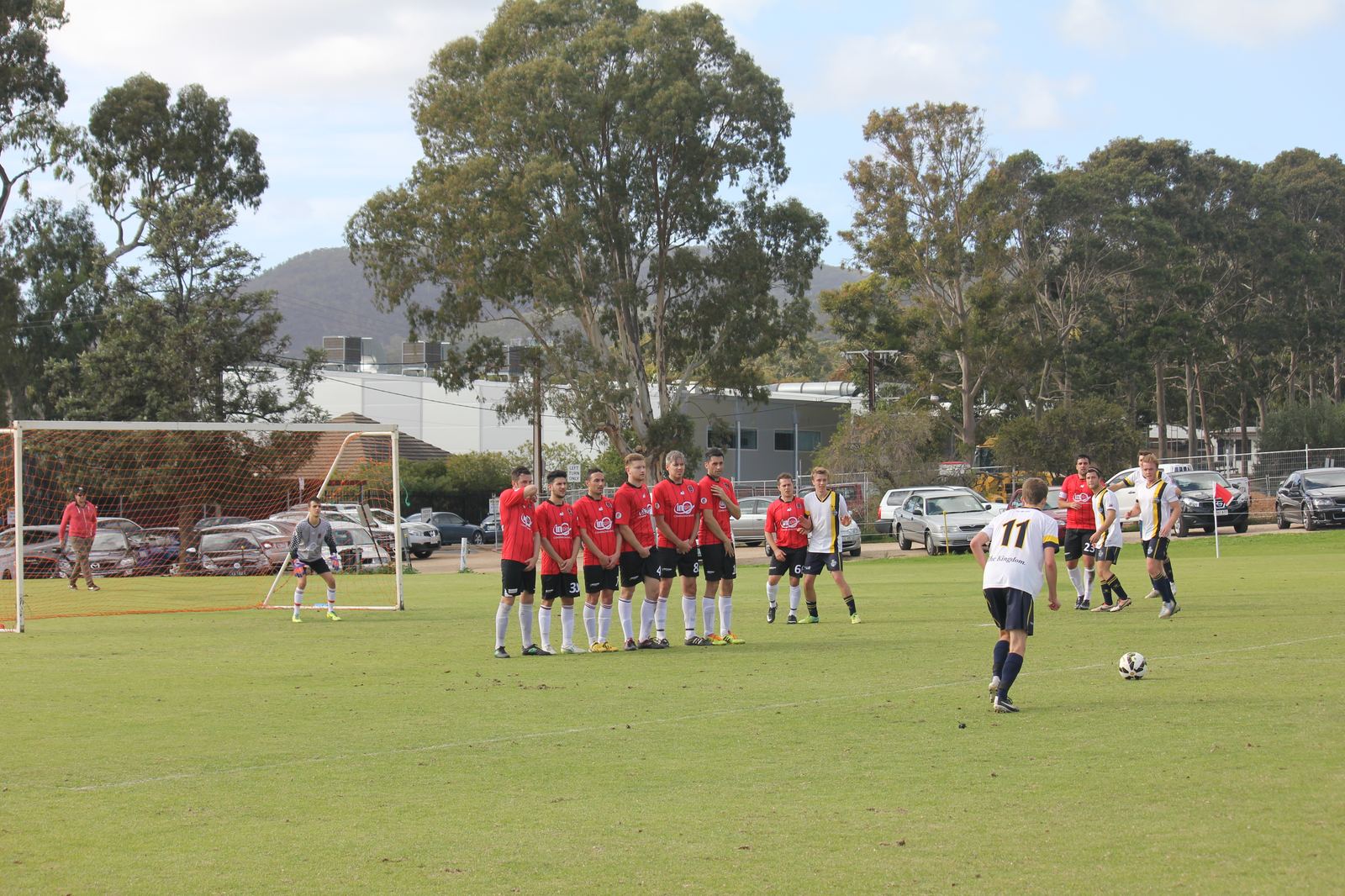 Zak lines up the free-kick as the wall sets