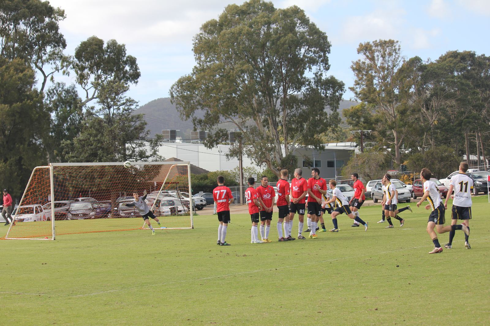 The goalkeeper dives full stretch