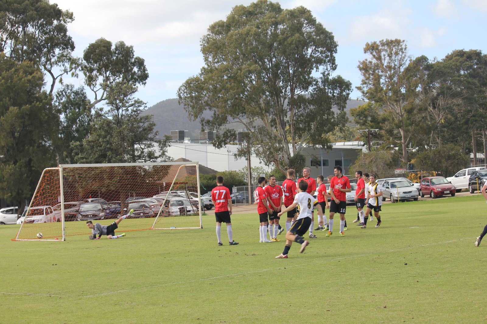 The ball hits the net as the keeper lands